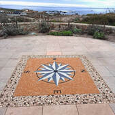 Outdoor floor compass rose mosaic installation