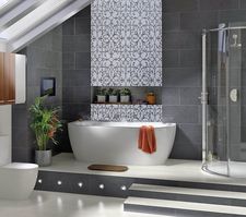 Patterned wall mosaic installation in bathroom