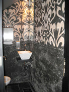 black and white scroll work mosaic installation for the bathroom walls